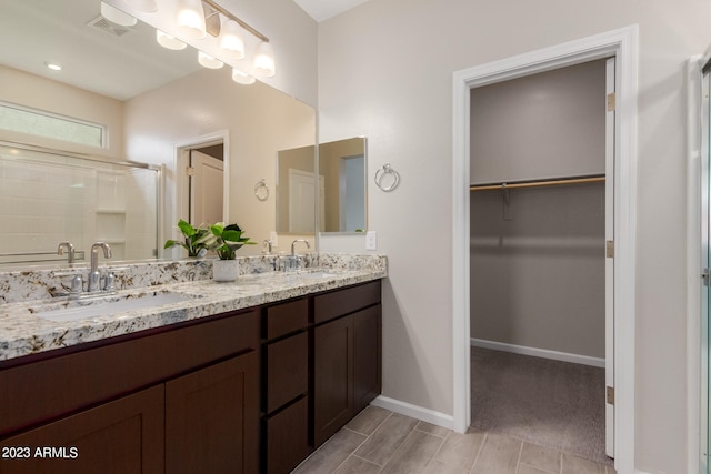 bathroom with vanity and an enclosed shower