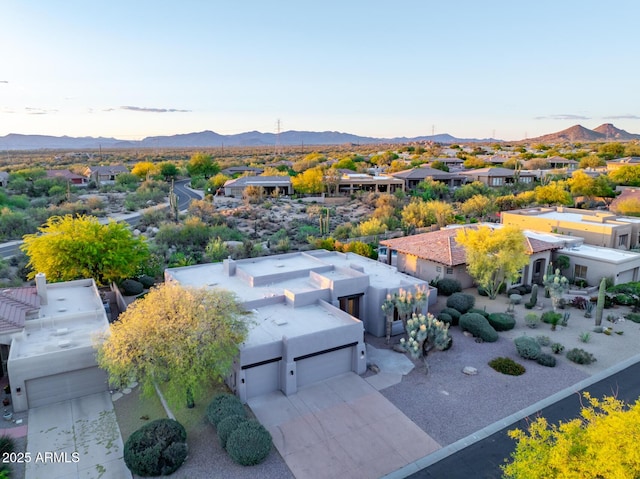 aerial view at dusk of a residential view and a mountain view