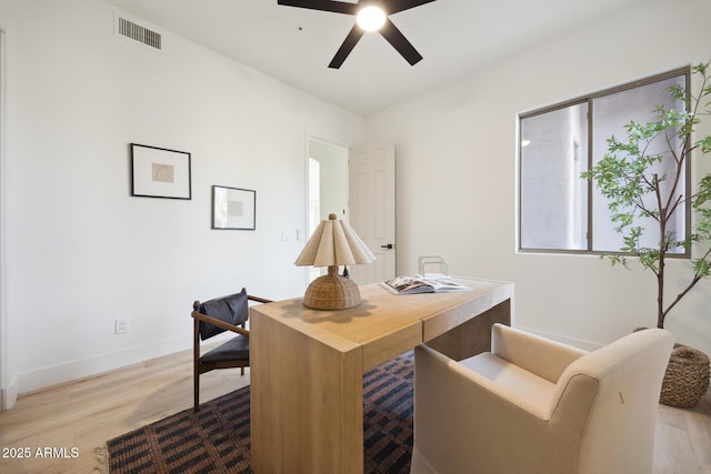 office space featuring wood finished floors, a ceiling fan, and baseboards
