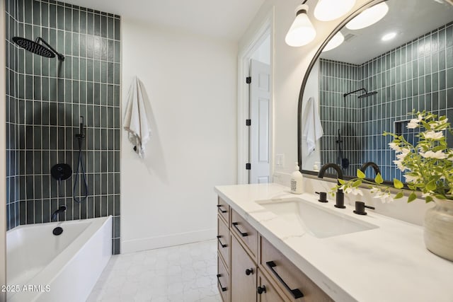 full bath with marble look tile flooring, tiled shower / bath combo, vanity, and baseboards
