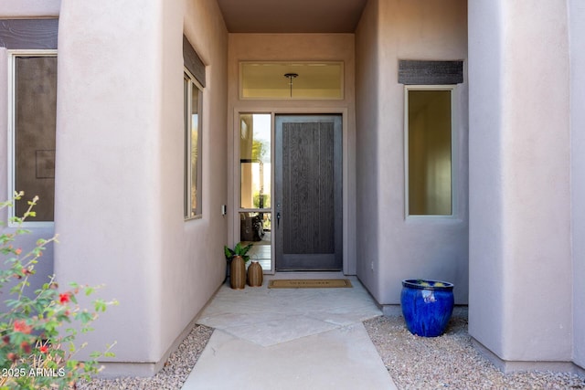 entrance to property with stucco siding