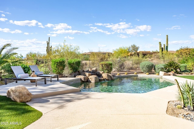 view of pool with a patio area and fence