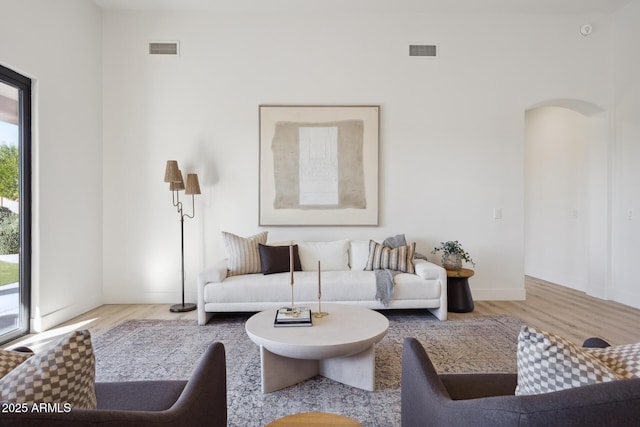 living room with healthy amount of natural light, wood finished floors, and baseboards