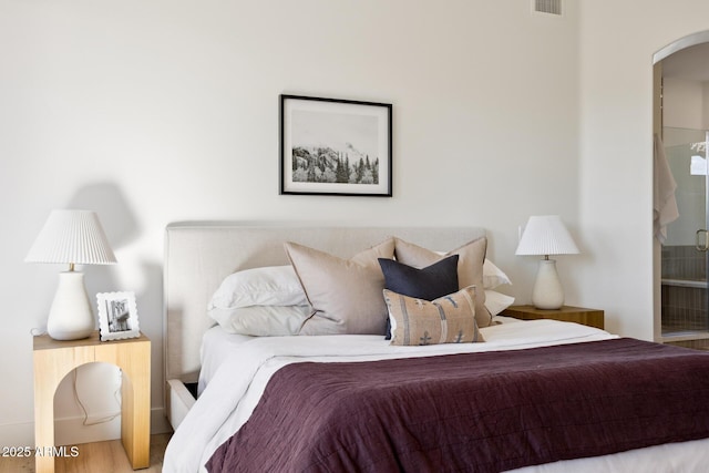bedroom with arched walkways