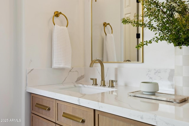 bathroom featuring vanity and decorative backsplash
