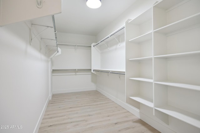 spacious closet featuring wood finished floors