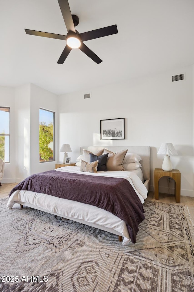 bedroom featuring baseboards, a ceiling fan, and wood finished floors