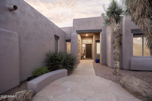 entrance to property with stucco siding