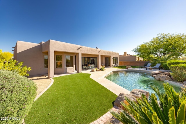 view of pool with a patio area and a yard
