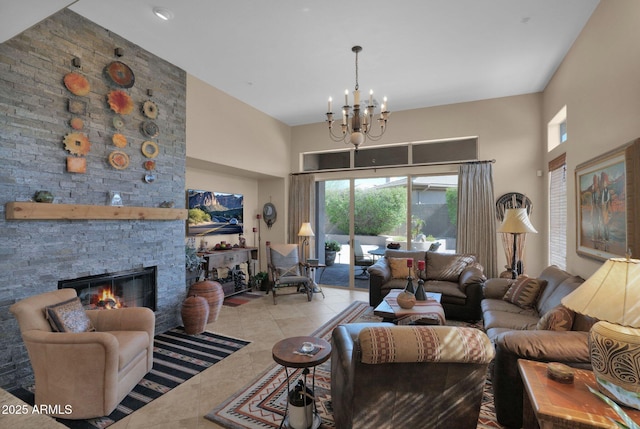 living room featuring a towering ceiling, an inviting chandelier, light tile patterned floors, and a stone fireplace