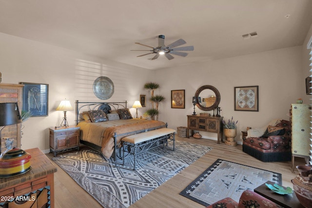 bedroom with visible vents and wood finished floors