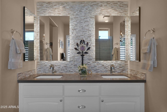 bathroom featuring tasteful backsplash, a sink, and double vanity