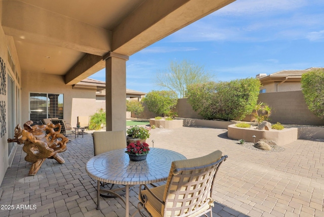 view of patio with outdoor dining area and a fenced backyard