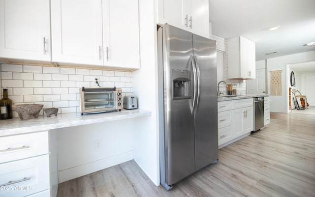 2320 E Mulberry Dr, Phoenix, AZ 85016 - kitchen with white cabinets, tasteful backsplash, a sink, light wood-style flooring, and stainless steel appliances