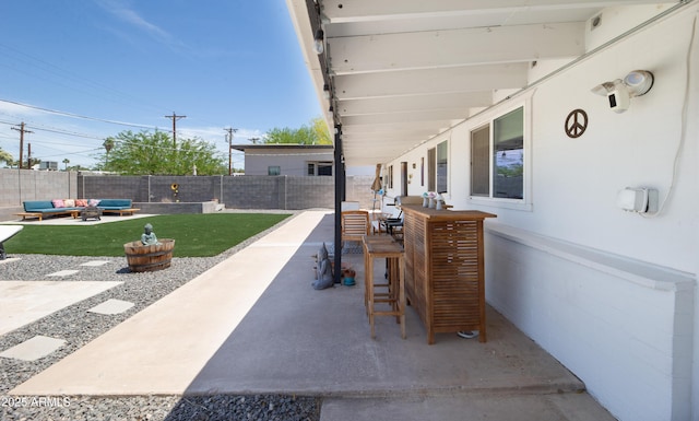 2320 E Mulberry Dr, Phoenix, AZ 85016 - view of patio with outdoor dining area, a fenced backyard, and an outdoor living space with a fire pit