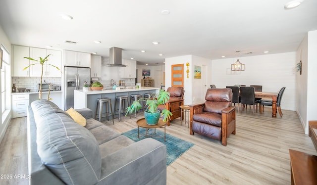2320 E Mulberry Dr, Phoenix, AZ 85016 - living room featuring light wood-style floors, a notable chandelier, recessed lighting, and visible vents