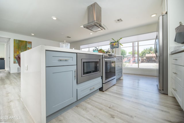 2320 E Mulberry Dr, Phoenix, AZ 85016 - kitchen with appliances with stainless steel finishes, light wood-style floors, recessed lighting, island exhaust hood, and visible vents
