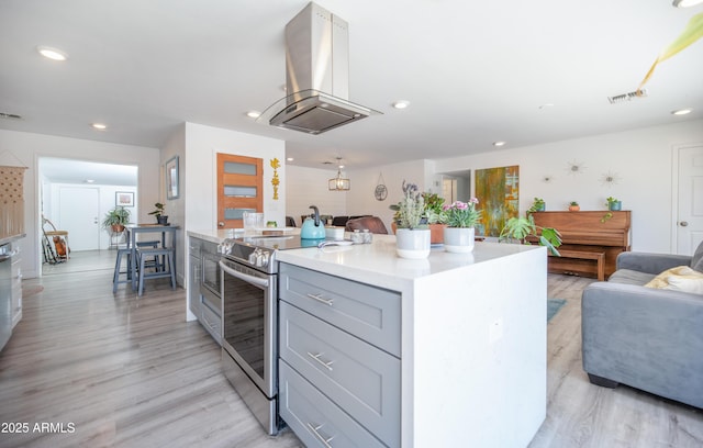 2320 E Mulberry Dr, Phoenix, AZ 85016 - kitchen featuring electric range, gray cabinets, open floor plan, and island exhaust hood