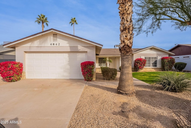 ranch-style house featuring a garage and a front yard