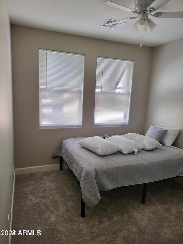 bedroom featuring dark carpet and ceiling fan