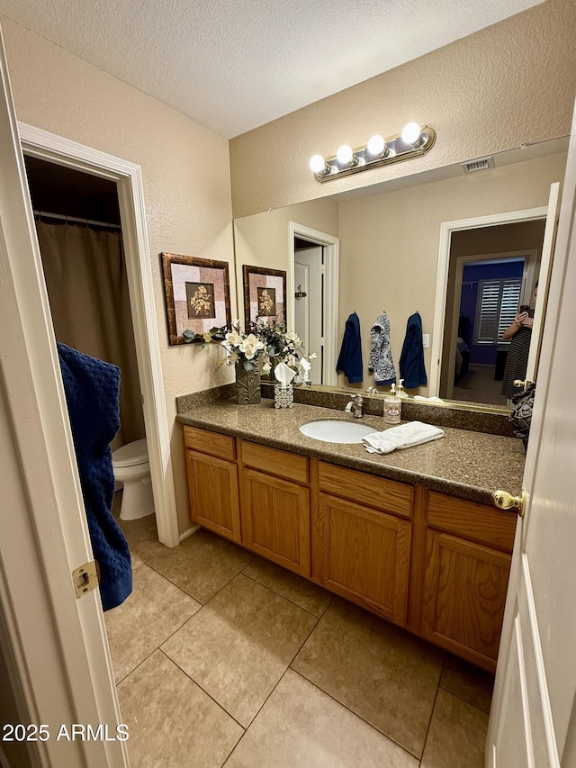 3891 E Simpson Rd, Gilbert, AZ 85297 - bathroom featuring vanity, a textured wall, a textured ceiling, and tile patterned flooring