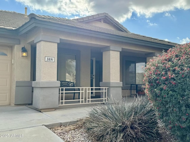 3891 E Simpson Rd, Gilbert, AZ 85297 - property entrance featuring a porch and a tiled roof