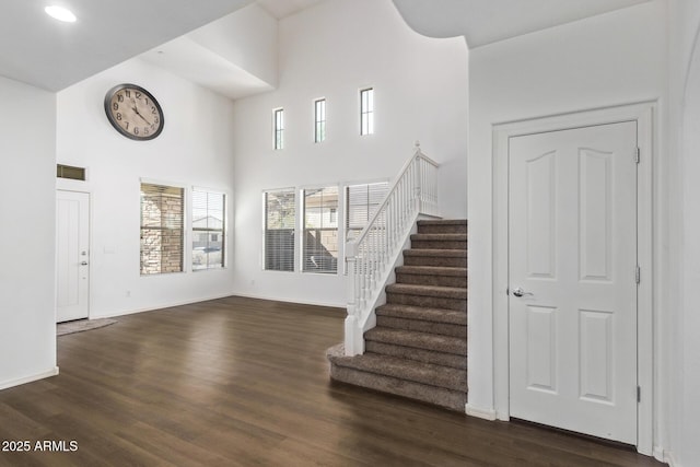 foyer featuring dark hardwood / wood-style flooring and a high ceiling