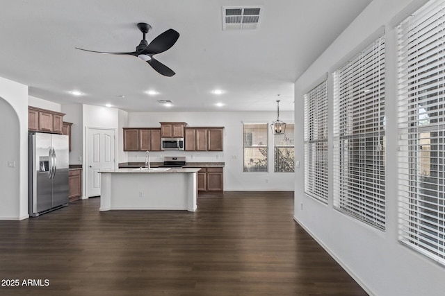 kitchen with dark hardwood / wood-style floors, sink, a kitchen island with sink, ceiling fan, and stainless steel appliances