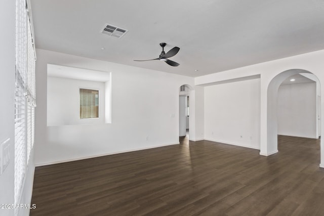 spare room with ceiling fan and dark hardwood / wood-style floors