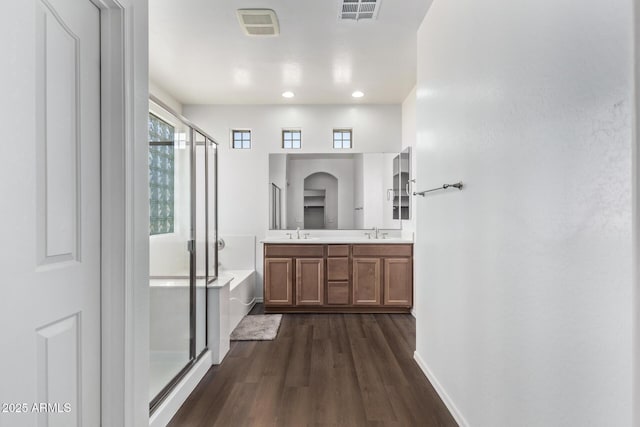 bathroom with hardwood / wood-style flooring, vanity, and independent shower and bath