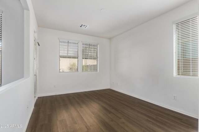 spare room with dark wood-type flooring