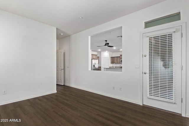 spare room featuring ceiling fan and dark hardwood / wood-style flooring