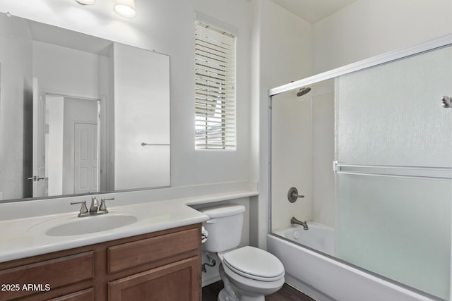 full bathroom with vanity, toilet, and combined bath / shower with glass door