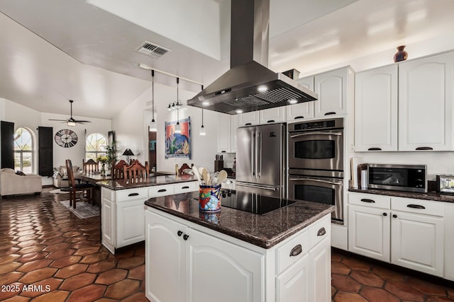 kitchen featuring visible vents, island exhaust hood, ceiling fan, stainless steel appliances, and a center island