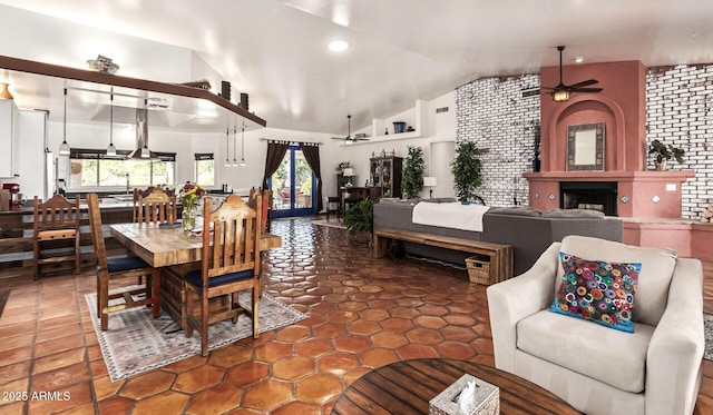 dining space with a large fireplace, vaulted ceiling, recessed lighting, and a ceiling fan