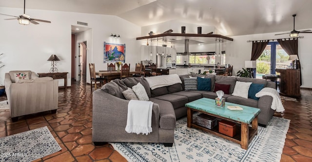 living area featuring lofted ceiling, visible vents, tile patterned flooring, and a ceiling fan