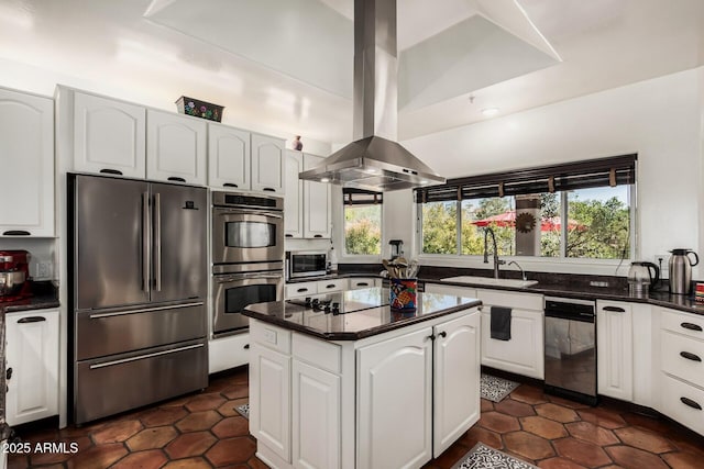 kitchen with white cabinetry, a center island, island exhaust hood, a sink, and appliances with stainless steel finishes