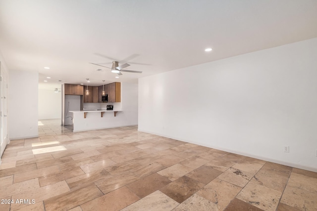 unfurnished living room with ceiling fan