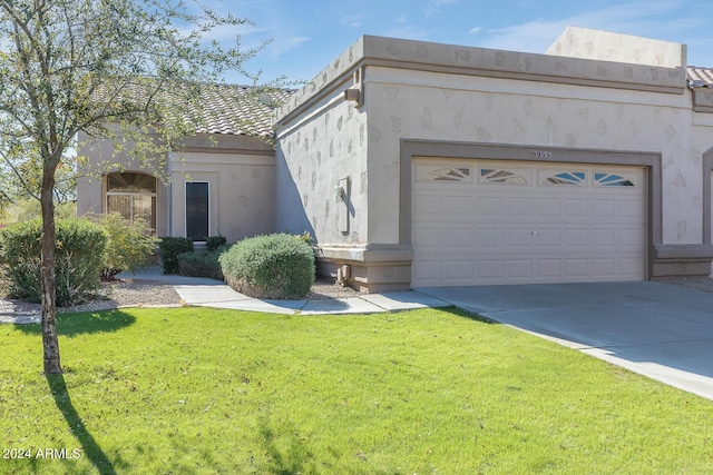 view of front of house with a front yard and a garage