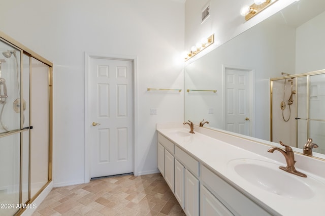 bathroom with a shower with door and vanity