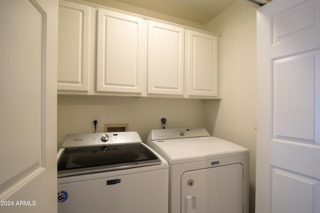 laundry room with cabinets and washing machine and clothes dryer