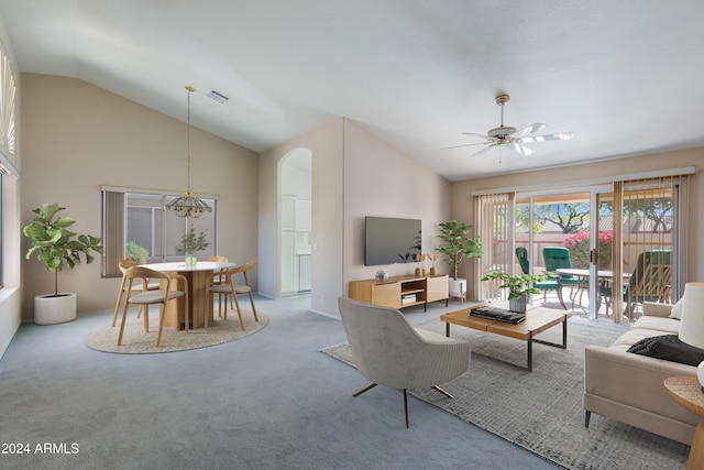 living room featuring carpet flooring, ceiling fan with notable chandelier, and lofted ceiling