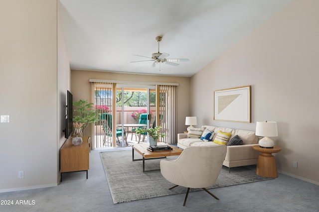 carpeted living room with ceiling fan and lofted ceiling