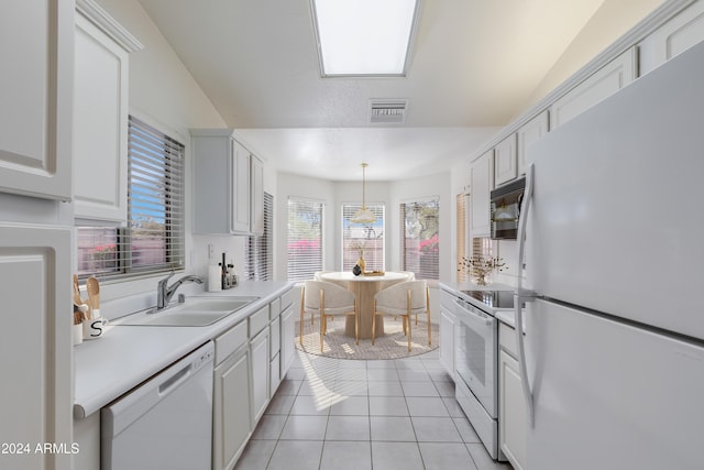 kitchen with white cabinetry, sink, pendant lighting, white appliances, and light tile patterned floors