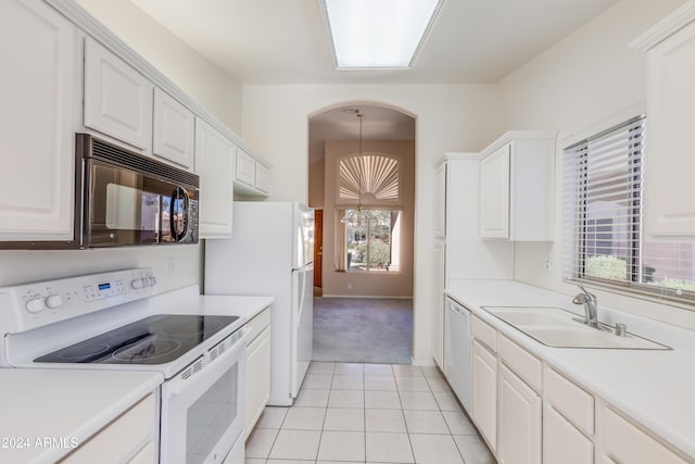 kitchen featuring white cabinetry, sink, a chandelier, and white appliances