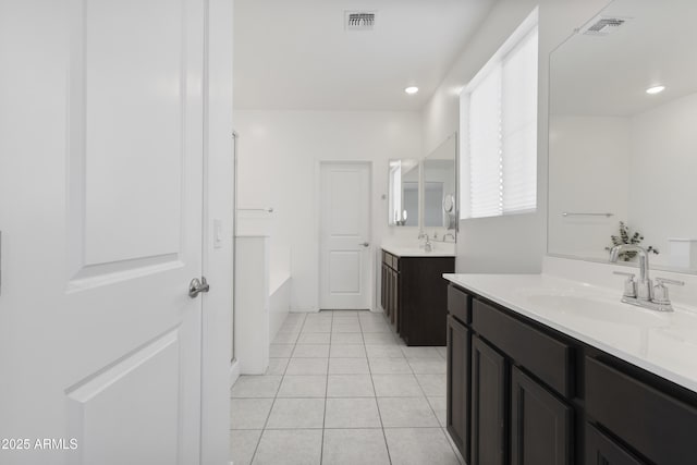 17721 W Cassia Way, Goodyear, AZ 85338 - full bathroom featuring a tub, two vanities, tile patterned floors, and recessed lighting
