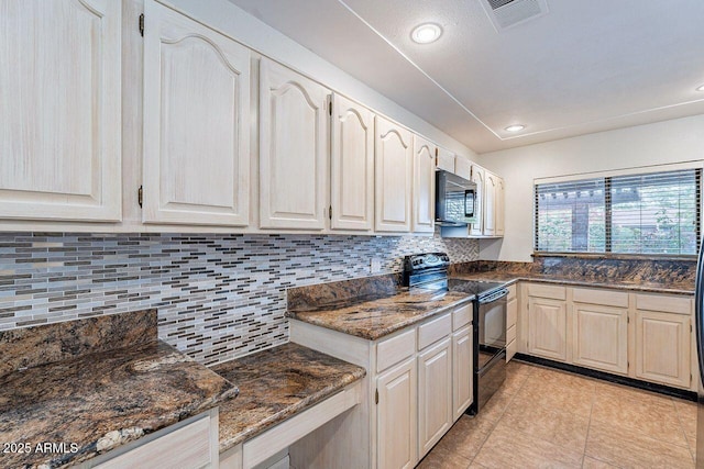 kitchen with visible vents, tasteful backsplash, black appliances, and dark stone counters