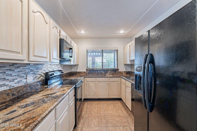 kitchen with tasteful backsplash, dark stone counters, recessed lighting, light tile patterned flooring, and black appliances