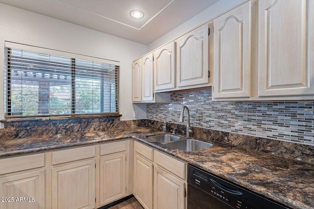 kitchen with a sink, dark stone counters, tasteful backsplash, and black dishwasher