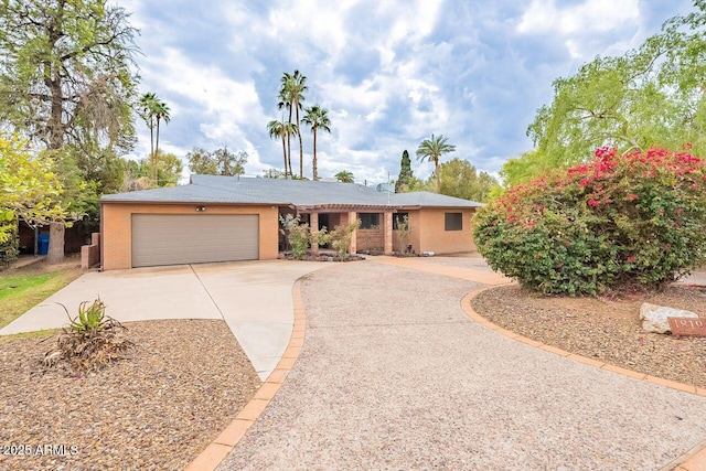 ranch-style house featuring a garage and concrete driveway